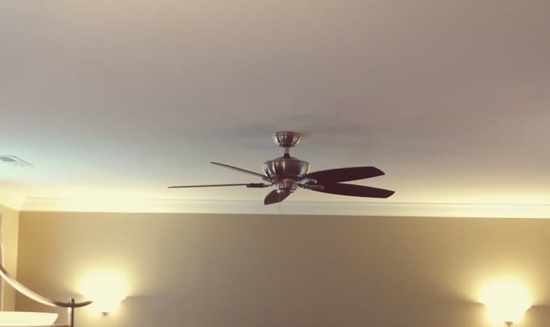 Installed ceiling fan in a bedroom